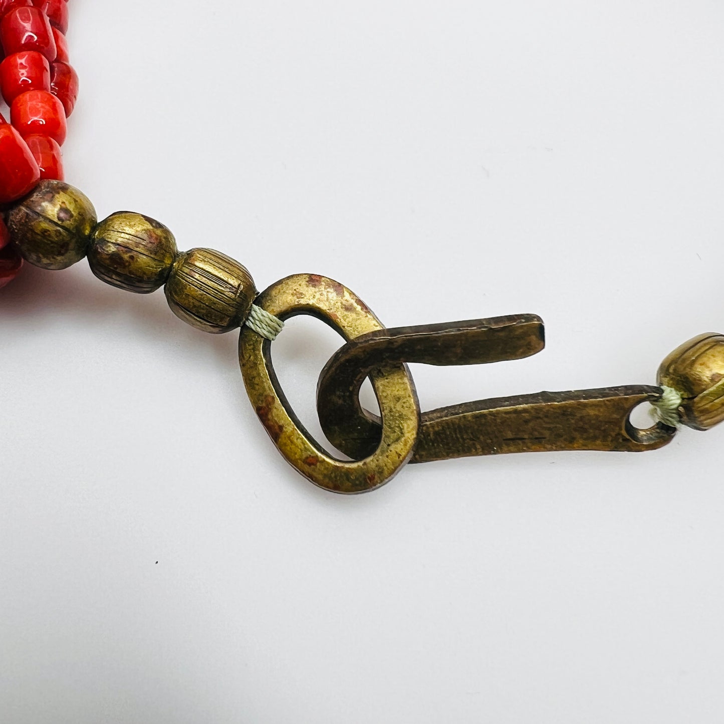 Brass hook clasp detail on vintage artisan bead necklace