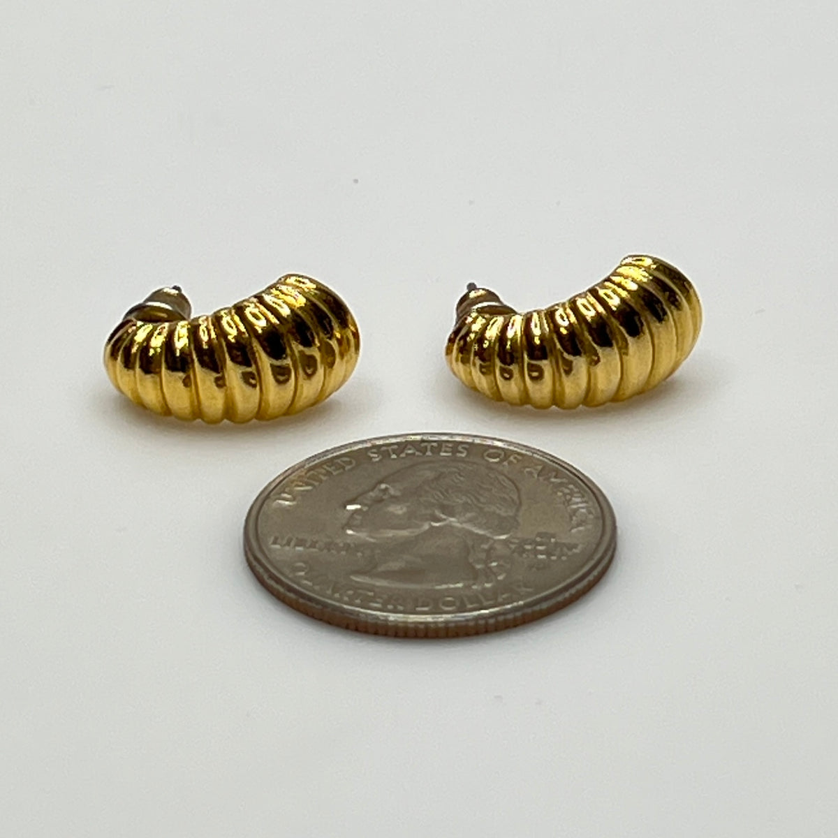 Matching crescent moon stud earrings in polished gold finish