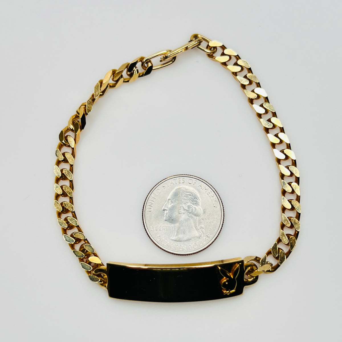 Gold tone chain bracelet with engraved Playboy Bunny plate