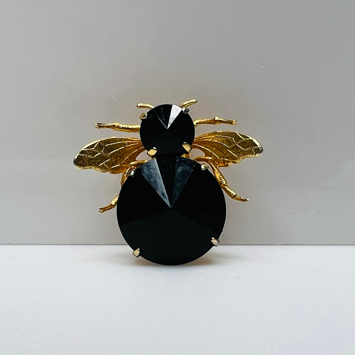 Gold-tone bee brooch with black faceted rhinestones, vintage insect pin