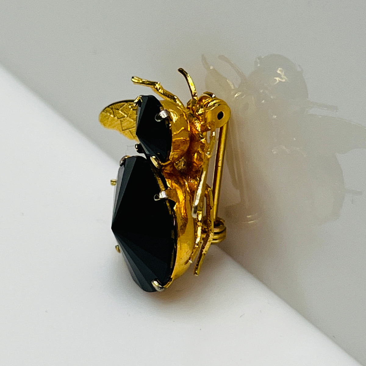 Gold-tone bee brooch with black faceted rhinestones, vintage insect pin