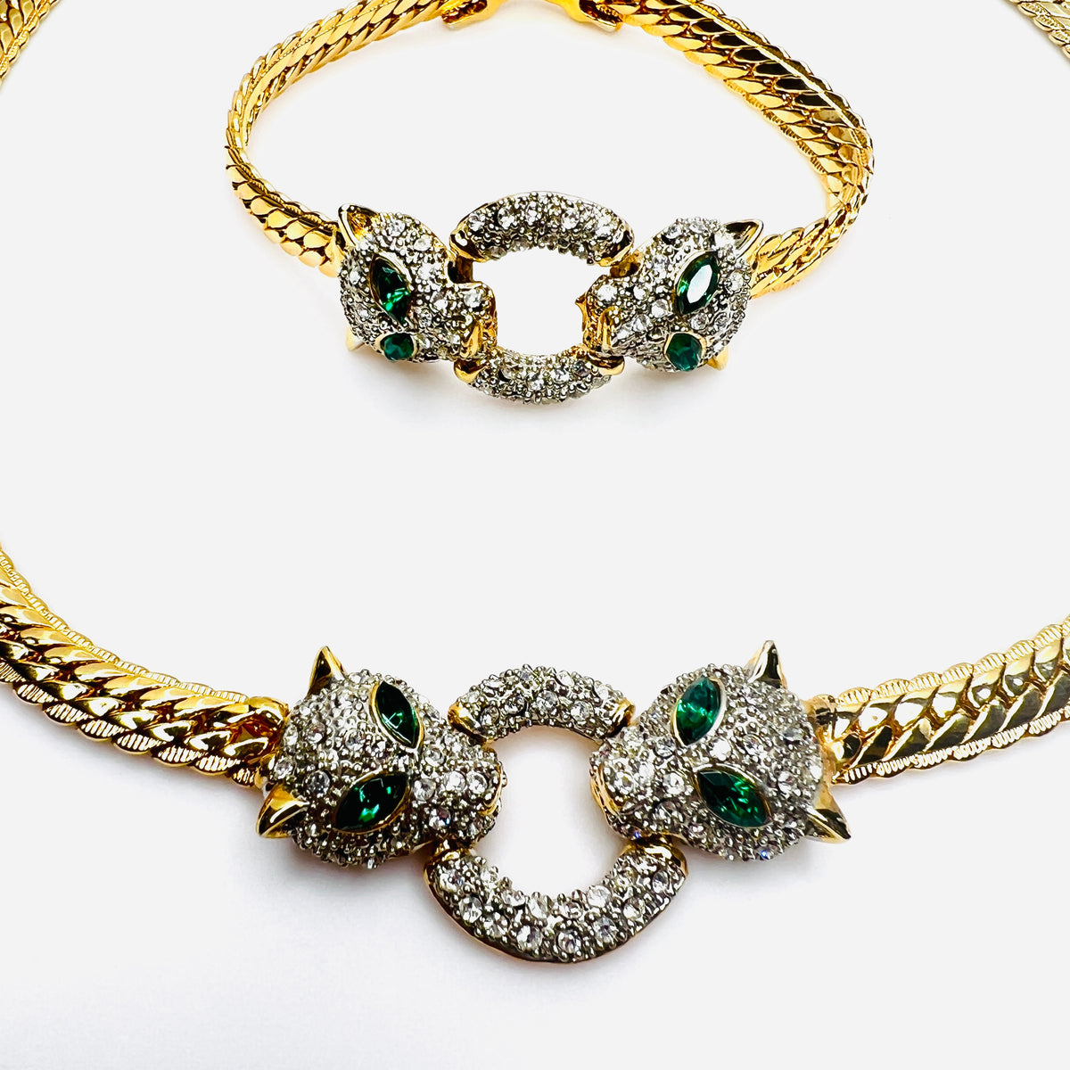 Close-up of rhinestone panther centerpiece with emerald green eyes on vintage jewelry set