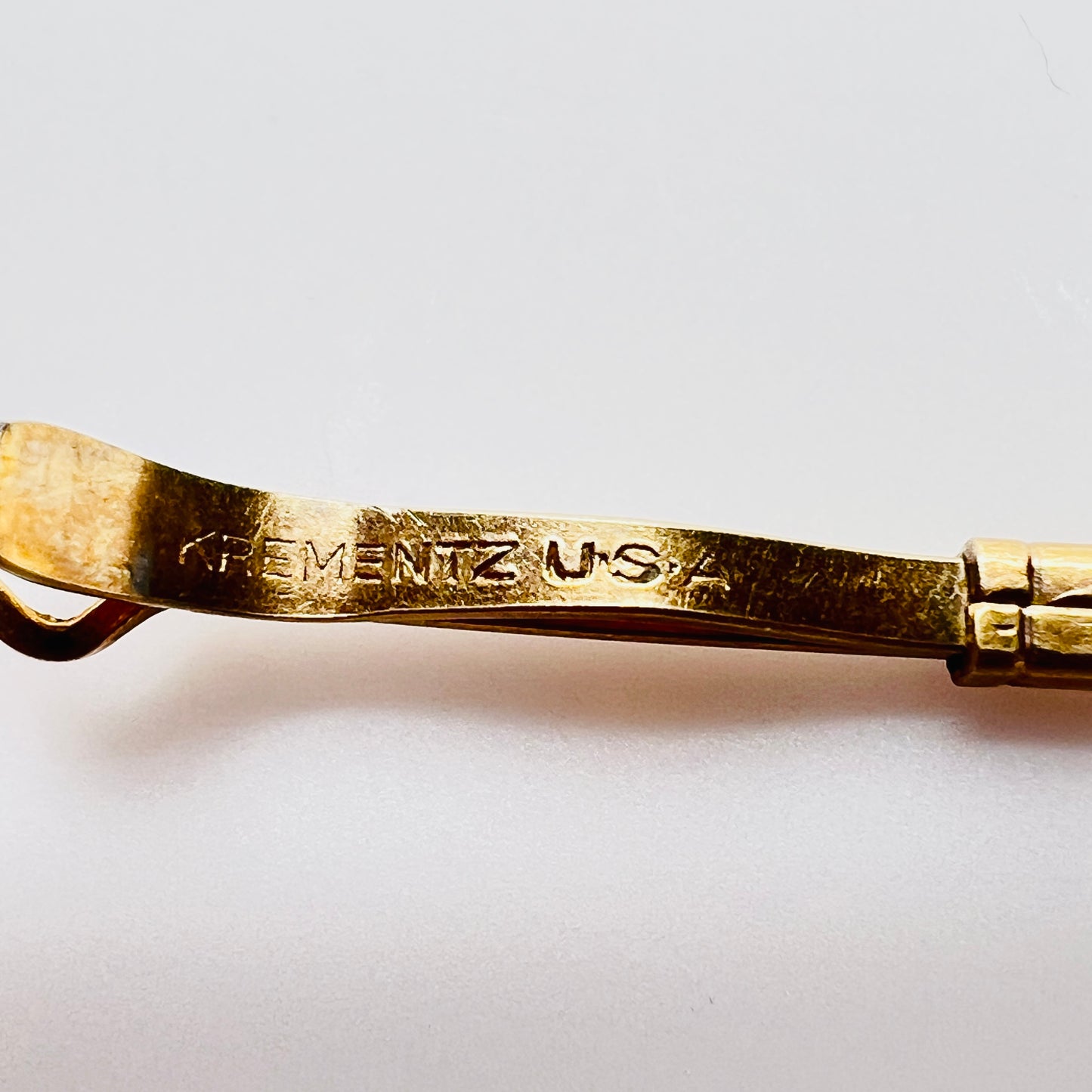 Krementz USA hallmark on vintage gold collar bar close up