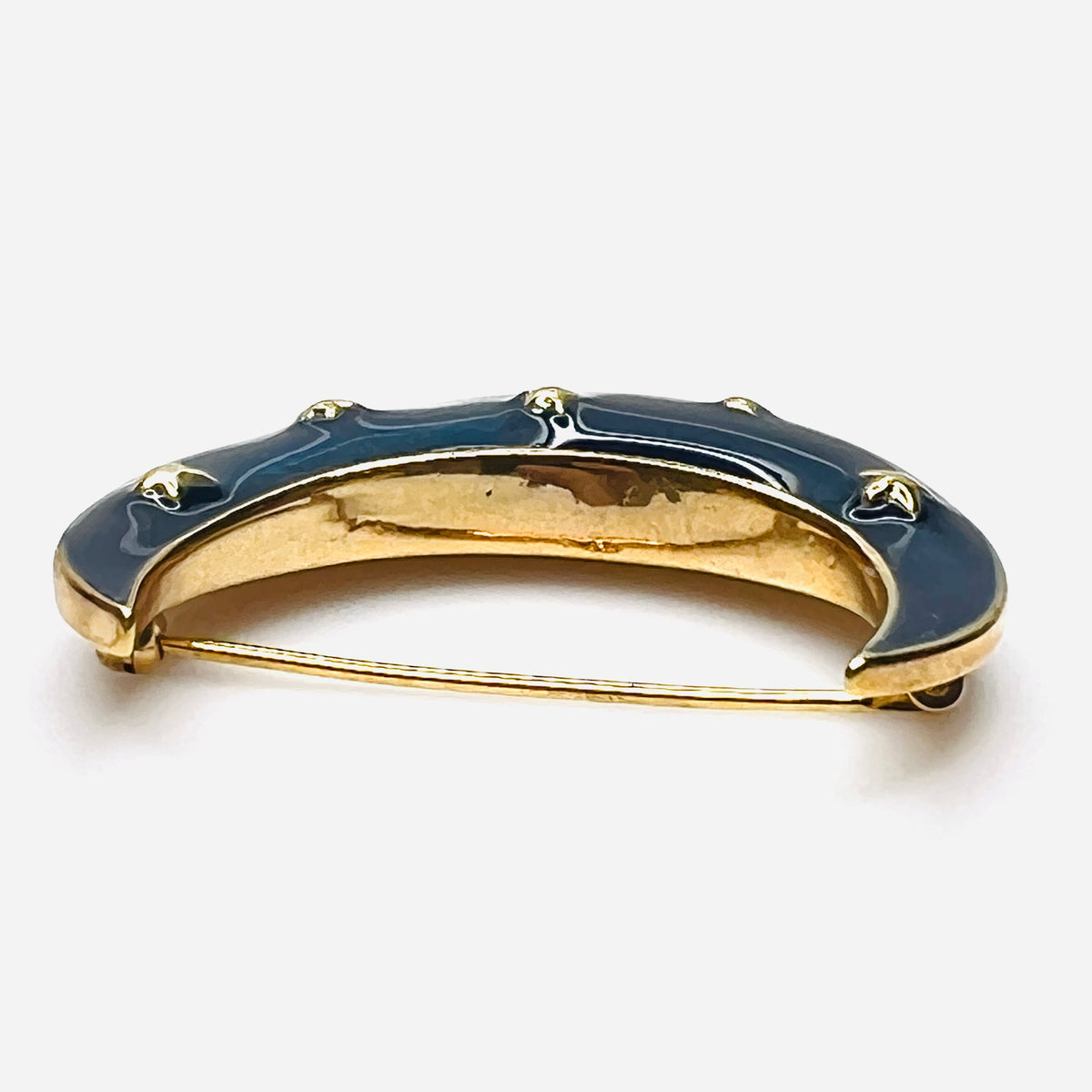 Side profile of vintage blue enamel crescent moon brooch with gold-tone finish.