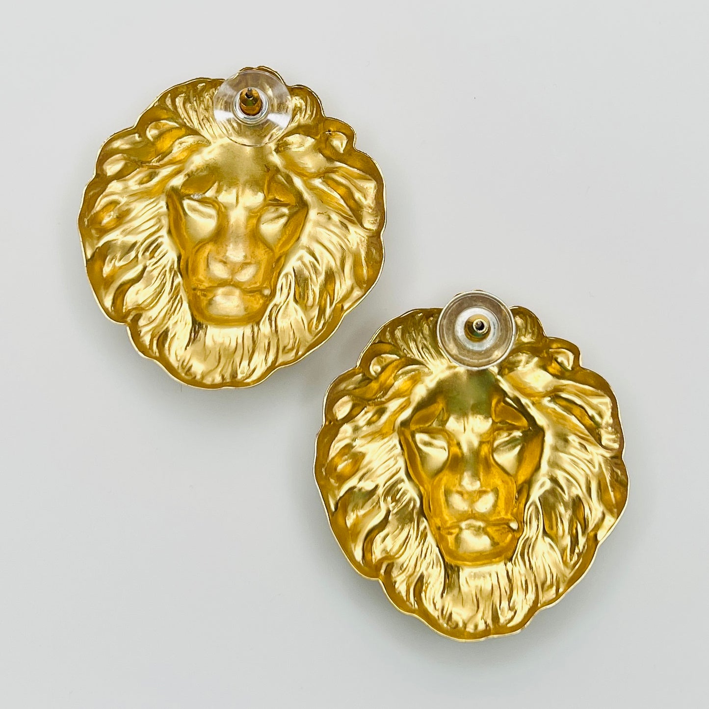 Reverse view of gold tone lion head earrings with push backs