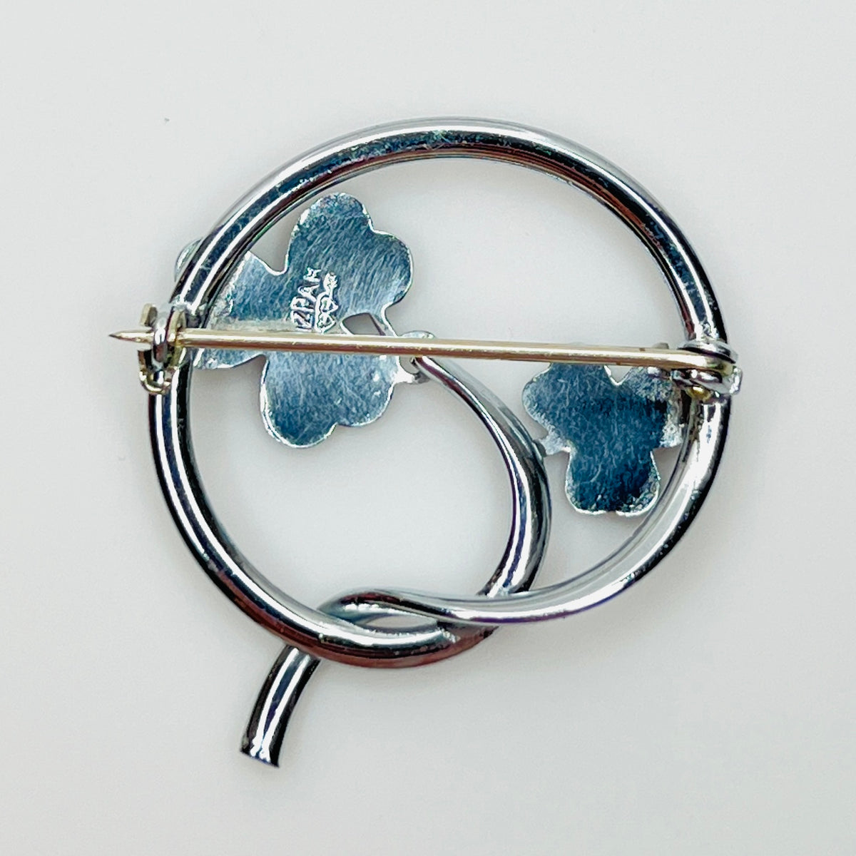 Reverse of signed Mizpah shamrock brooch with secure pin clasp and hallmark.