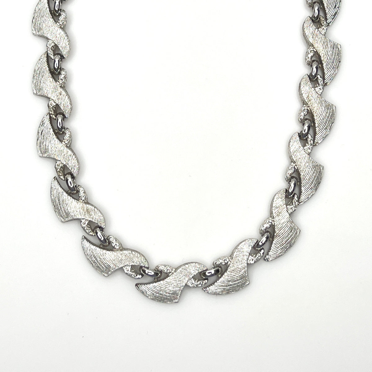 Vintage Monet silver tone textured swirl link choker necklace from the 1960s