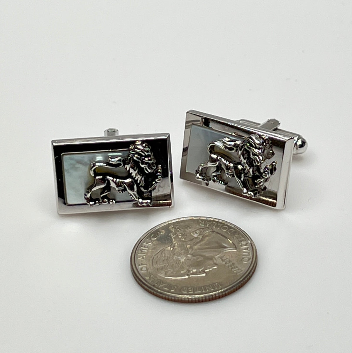 Rectangular silver cufflinks with mother of pearl inlay and raised silver lion motif