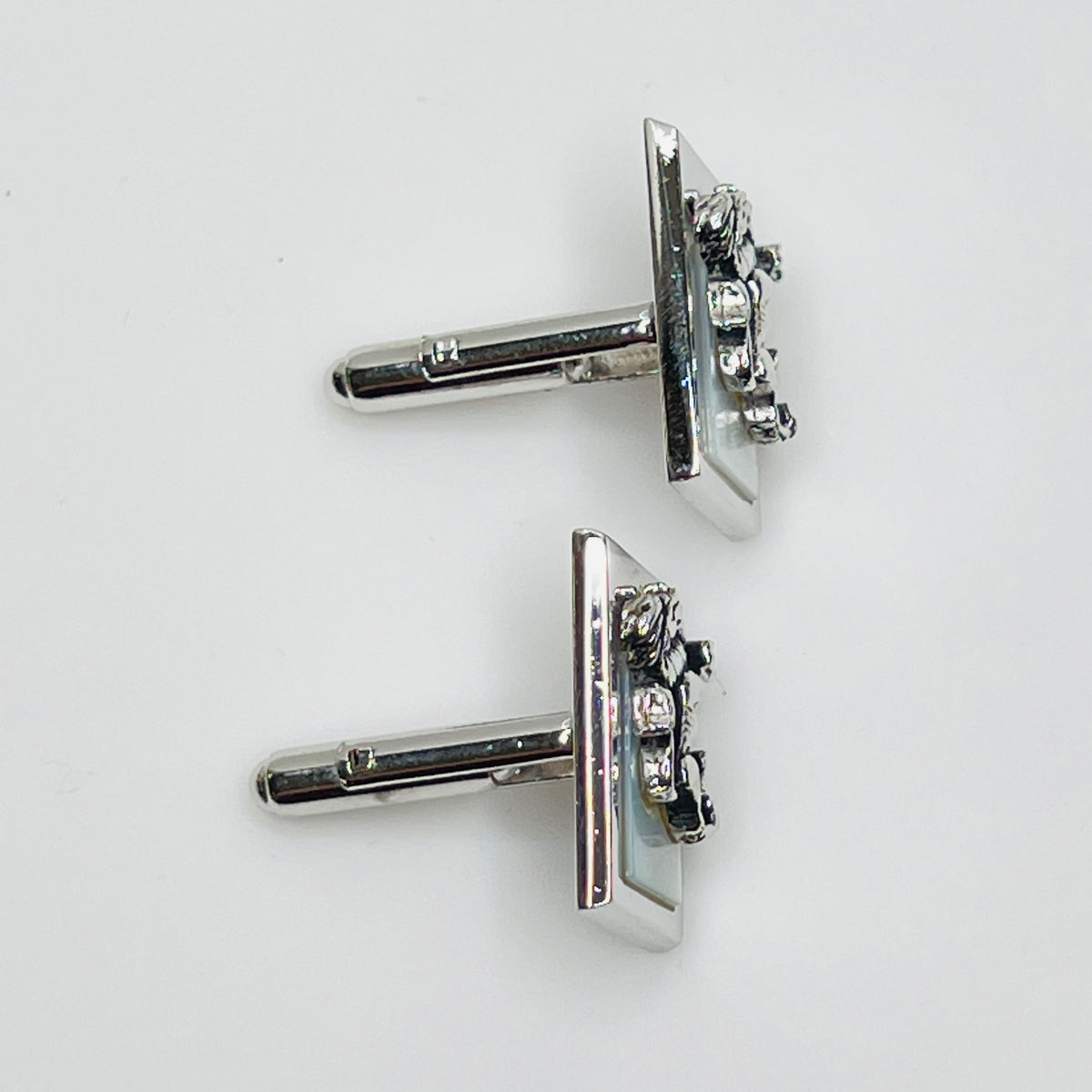 Rectangular silver cufflinks with mother of pearl inlay and raised silver lion motif
