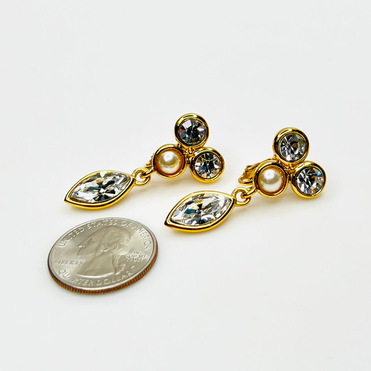 Napier rhinestone and faux pearl dangle clip-on earrings with quarter for scale