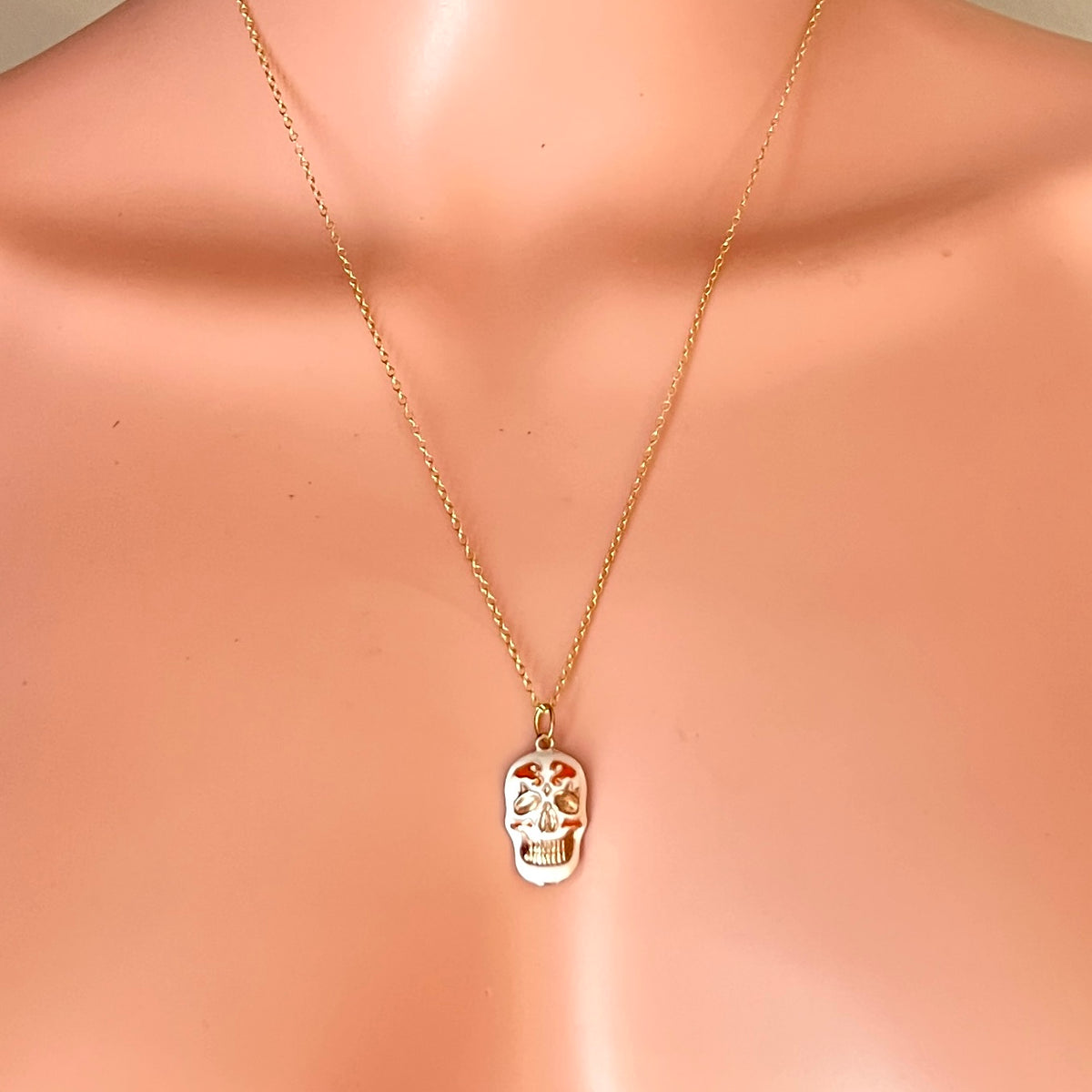 Vintage Day of the Dead skull pendant necklace displayed on mannequin.
