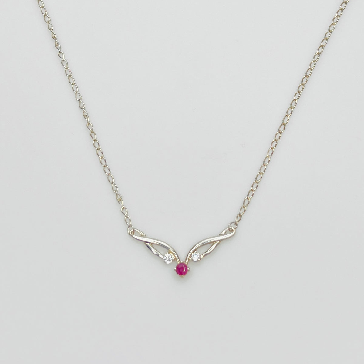 Sterling silver necklace with ruby center stone and CZ accents