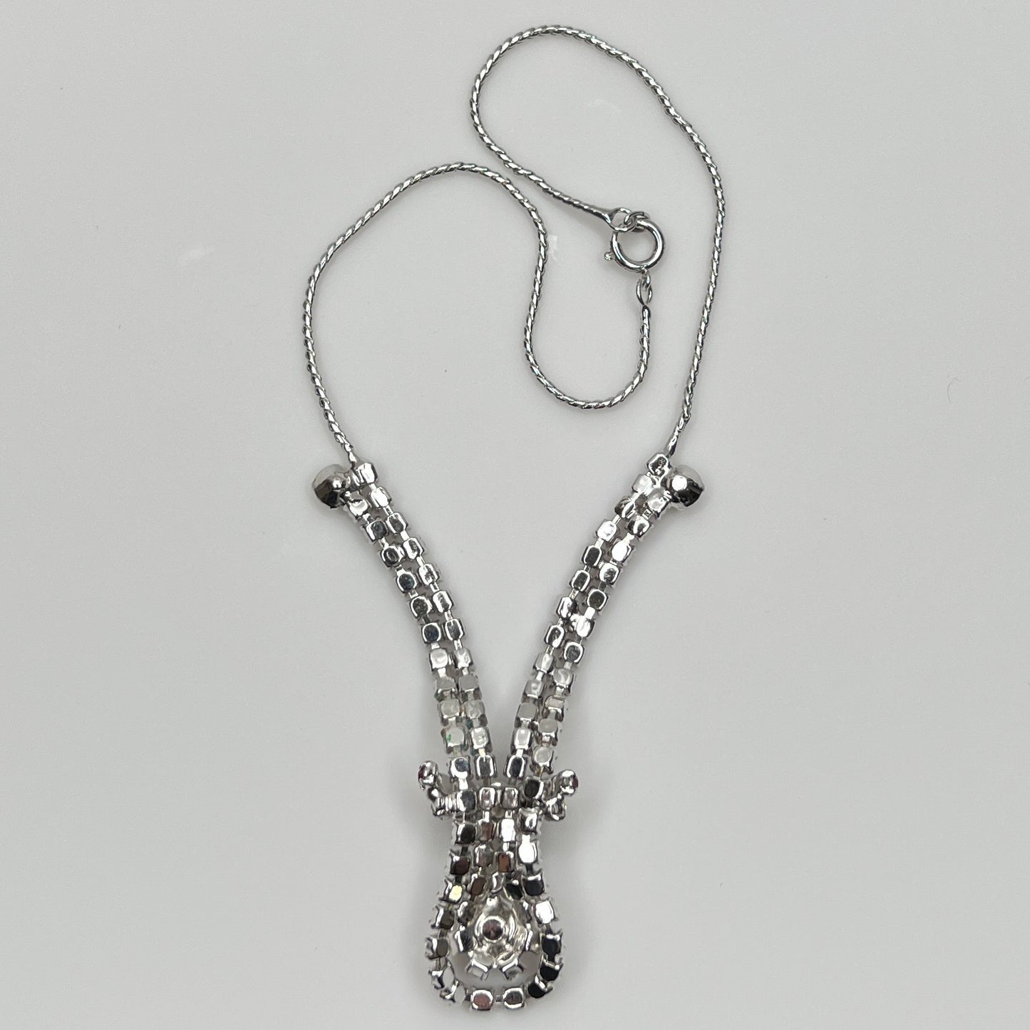 back of 1950s V-shaped red rhinestone drop necklace with spring ring clasp