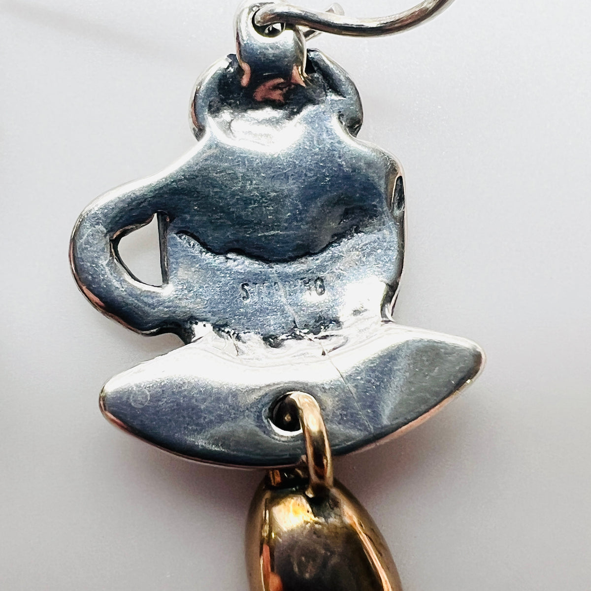 Reverse of vintage coffee cup earring showing sterling silver hallmark