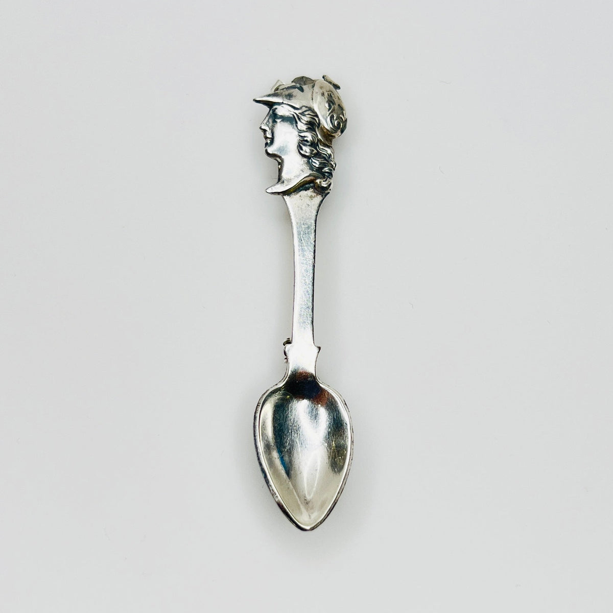 Vintage sterling silver spoon brooch with classical warrior profile
