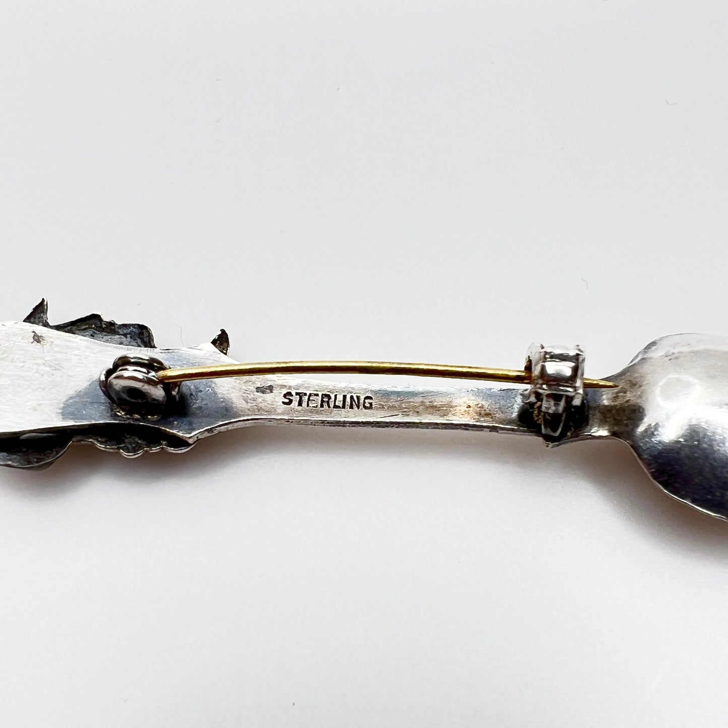 Back of sterling silver brooch showing sterling stamp