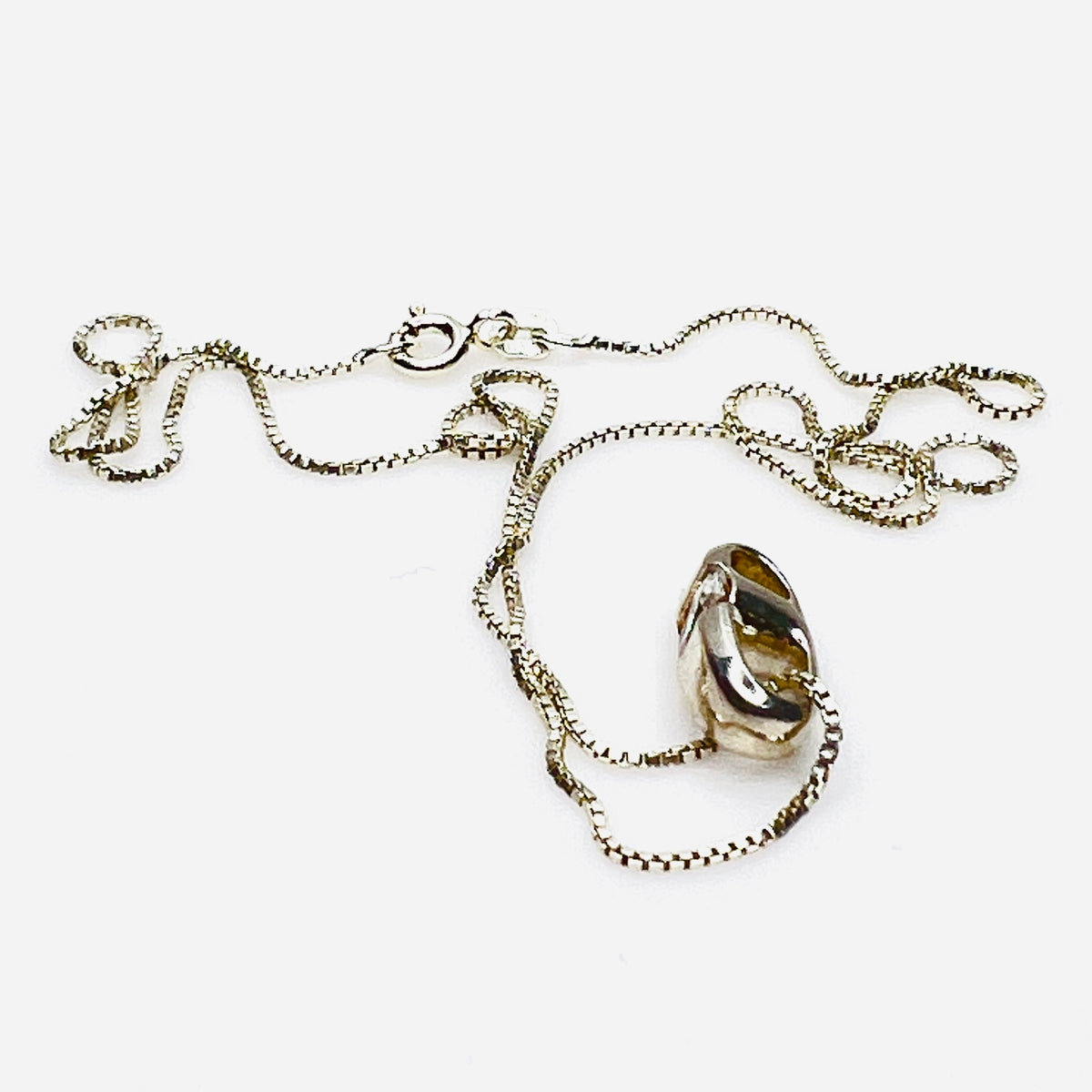 Side view of vintage sterling silver CZ pendant with Italian box chain.