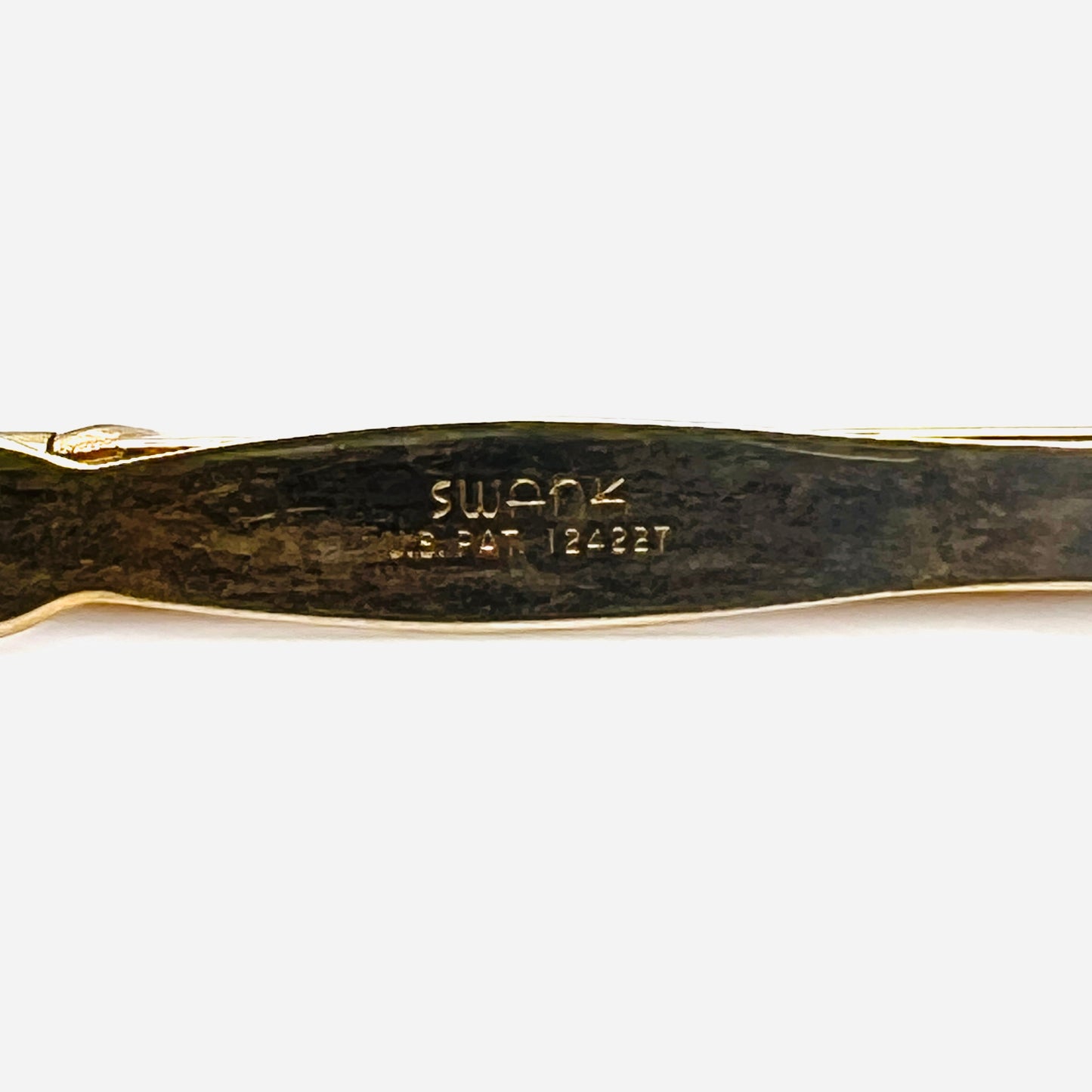 Close up of Swank signature and U.S. patent marking on vintage gold tone pencil tie clip