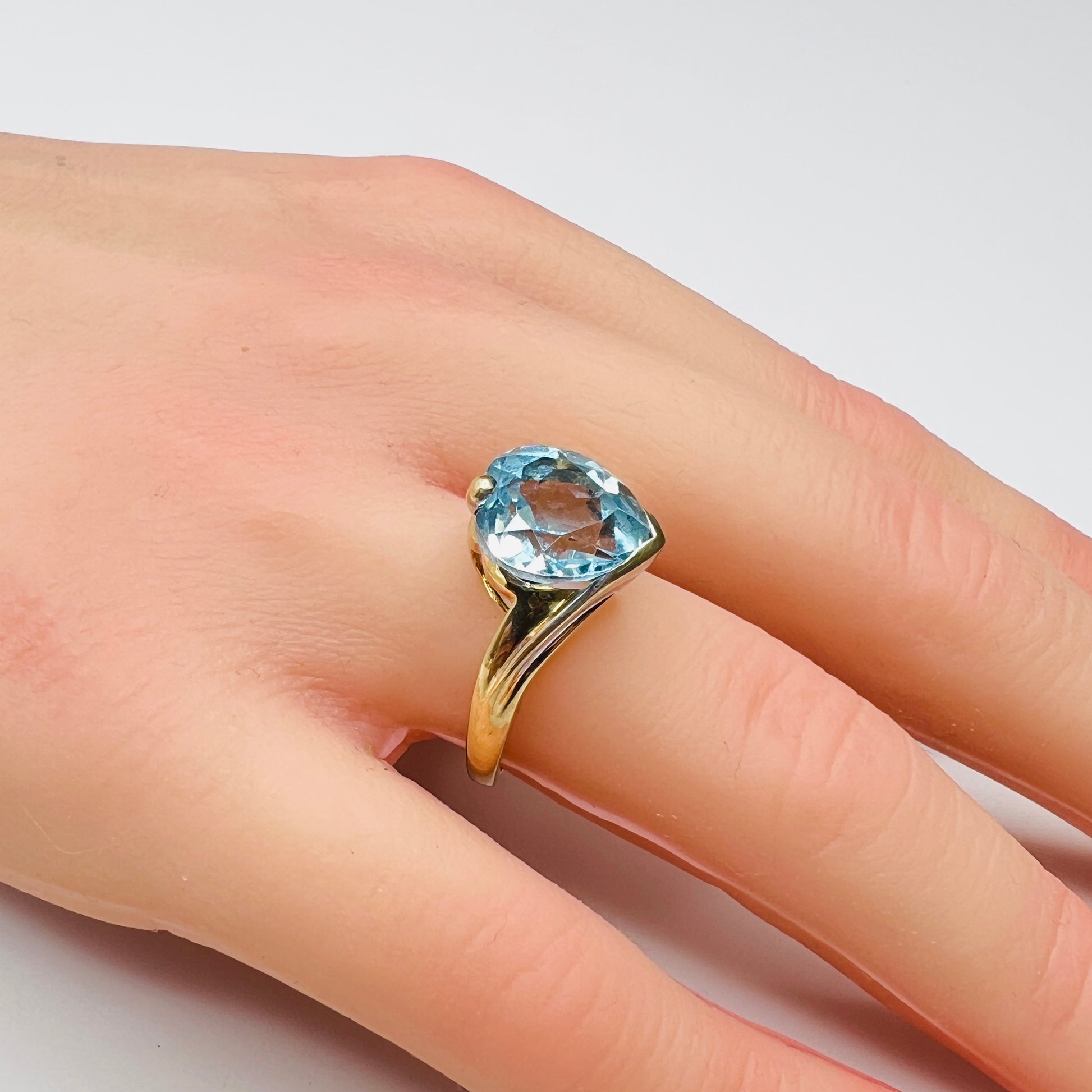Vintage 10K gold ring with heart-shaped aquamarine gemstone on hand