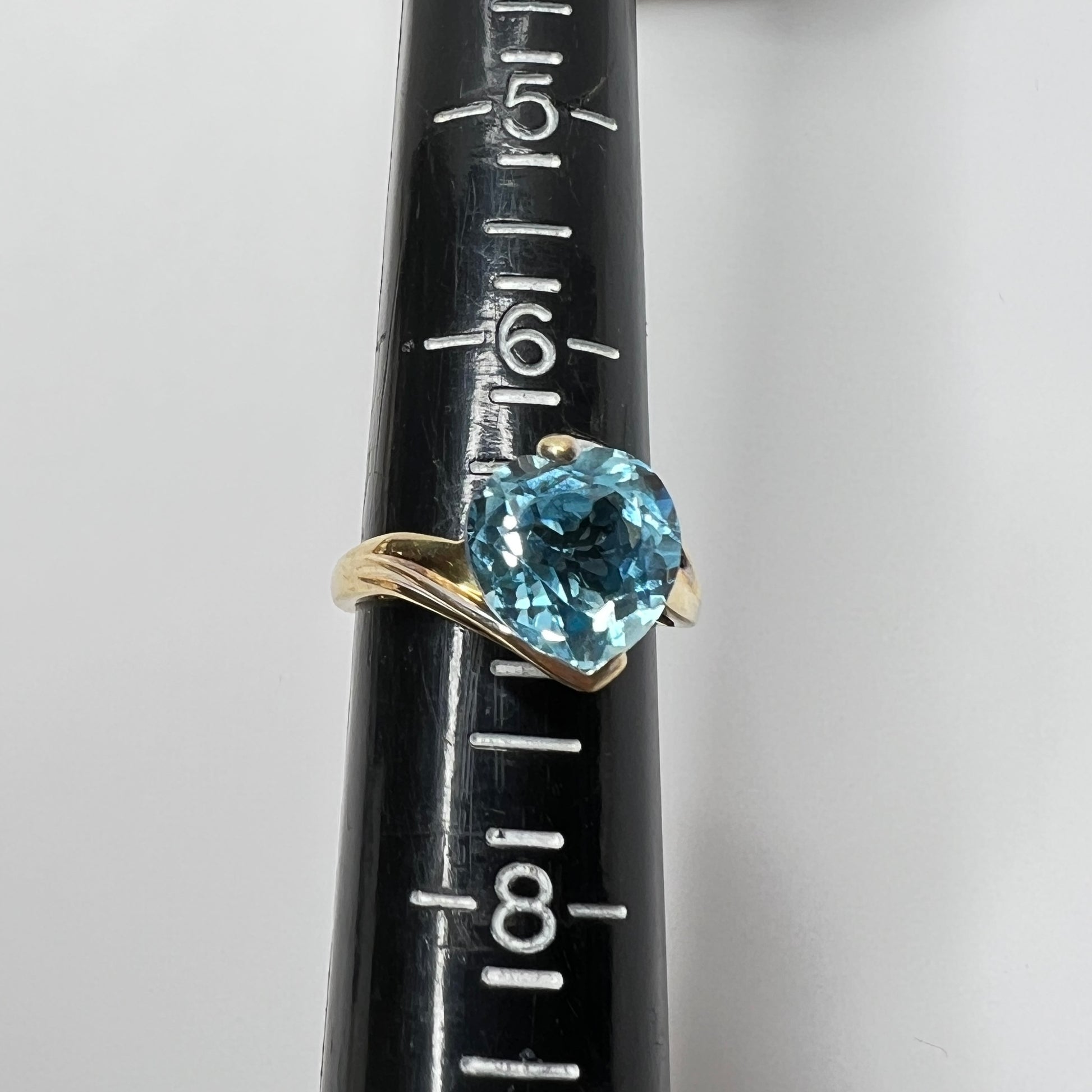 Close-up of aquamarine heart ring in two-tone yellow and white gold