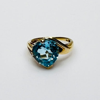 Close-up of aquamarine heart ring in two-tone yellow and white gold