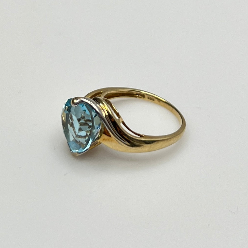 Close-up of aquamarine heart ring in two-tone yellow and white gold