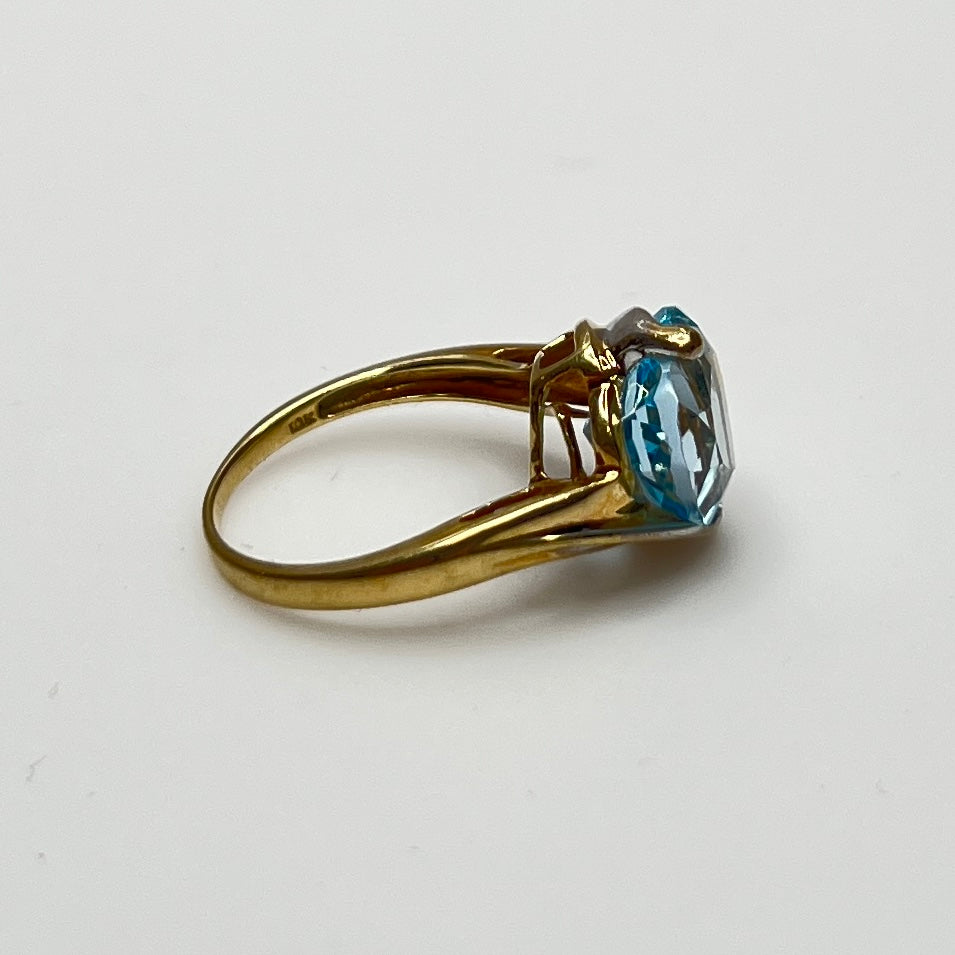 Close-up of aquamarine heart ring in two-tone yellow and white gold