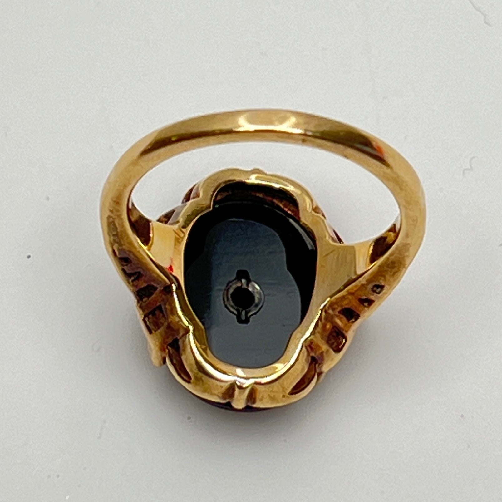 Close-up of prong-set black onyx cabochon with central diamond