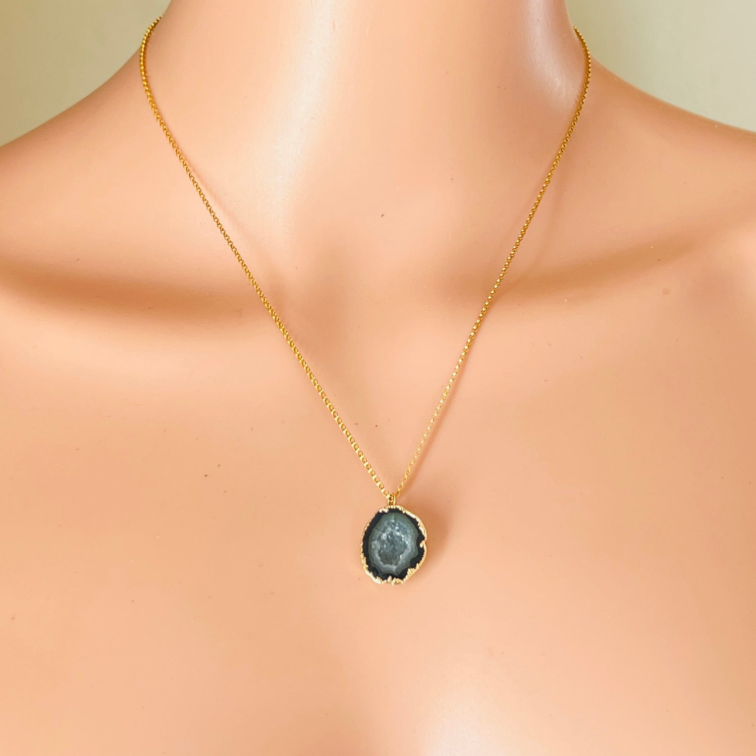 Black agate geode pendant necklace worn on neckline