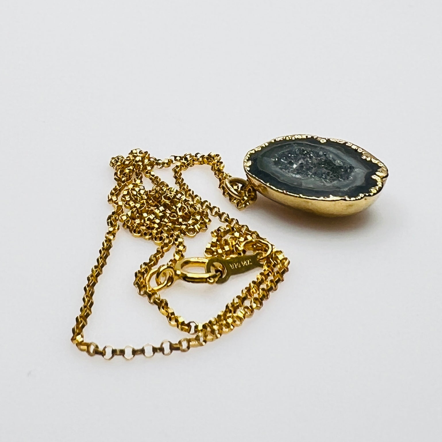 Close-up of geode slice pendant with gold bezel