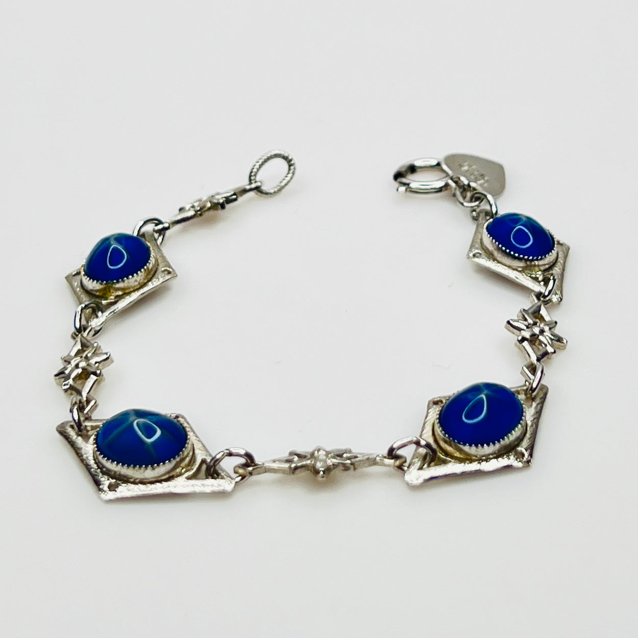 Overhead view of Sentiment bracelet showing blue cabochons and clasp
