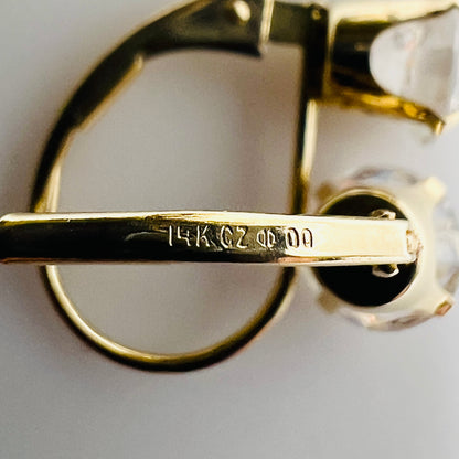 Close-up of earring stamp reading “14K CZ” and Diamonique logo