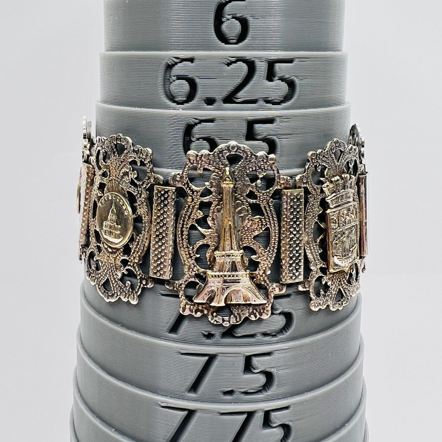 Vintage sterling silver Paris panel bracelet with Eiffel Tower motif on bracelet mandrel