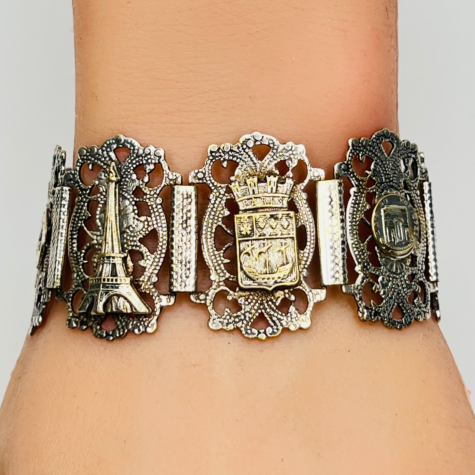 Filigree panel bracelet worn showing French crest and Eiffel Tower