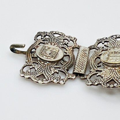Close-up of silver filigree panel and hook clasp detail