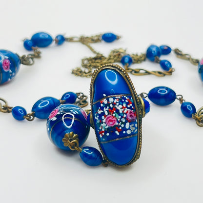 Ornate brass filigree fob pendant with blue glass