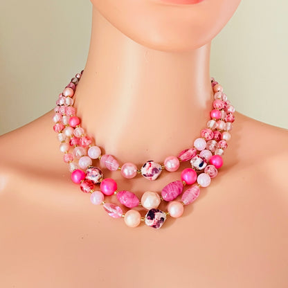 Layered pink beaded necklace worn on mannequin retro style