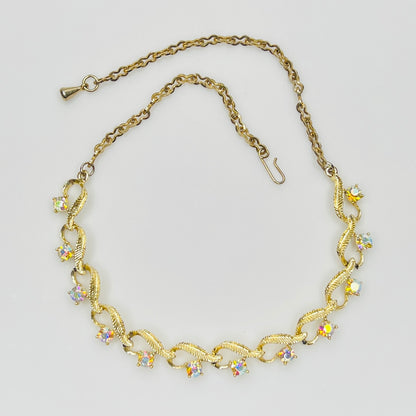 Flat lay of vintage aurora borealis choker with twisted gold links