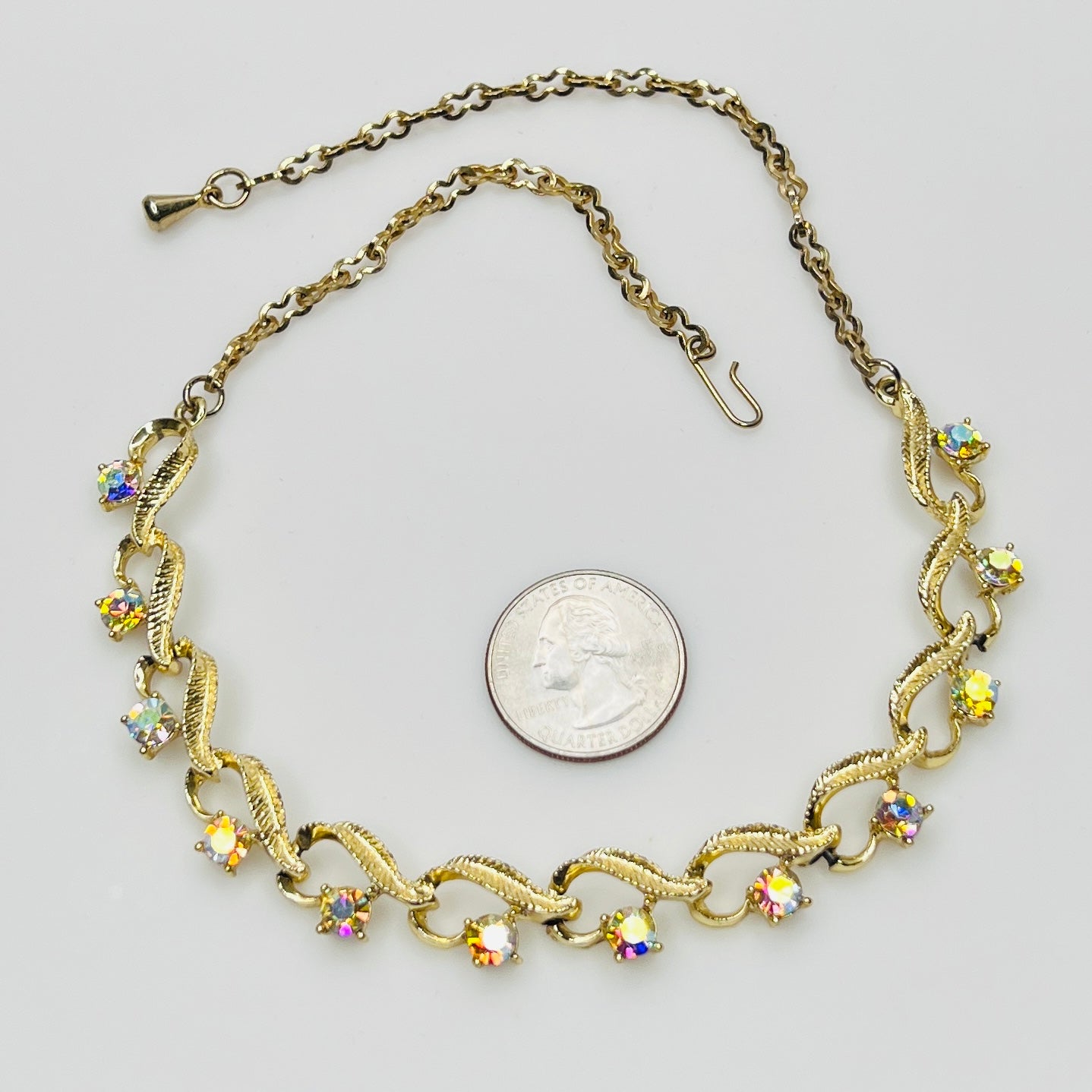 Flat lay of vintage aurora borealis choker with twisted gold links