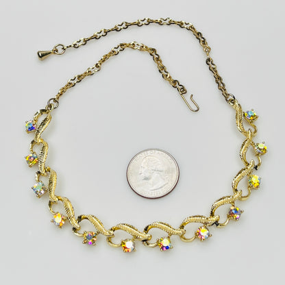 Flat lay of vintage aurora borealis choker with twisted gold links