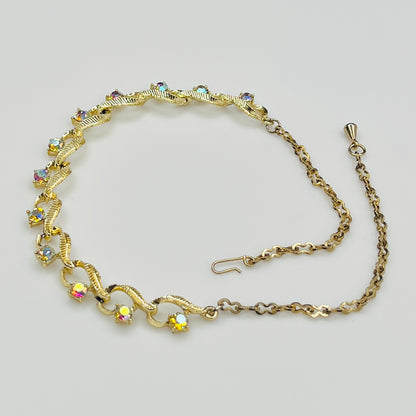 Flat lay of vintage aurora borealis choker with twisted gold links