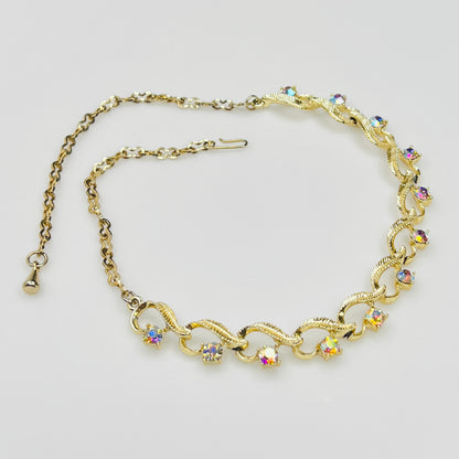 Flat lay of vintage aurora borealis choker with twisted gold links