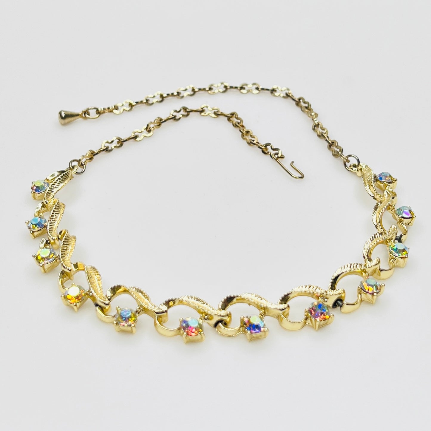 Flat lay of vintage aurora borealis choker with twisted gold links