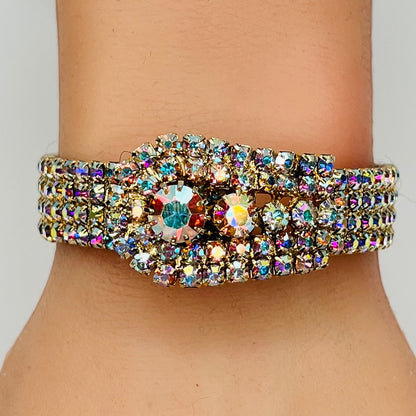 Vintage 1950s gold-tone clamper bracelet with Aurora Borealis rhinestones on wrist