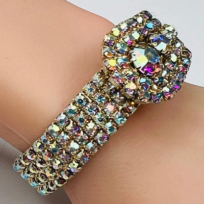 Vintage 1950s gold-tone clamper bracelet with Aurora Borealis rhinestones on wrist