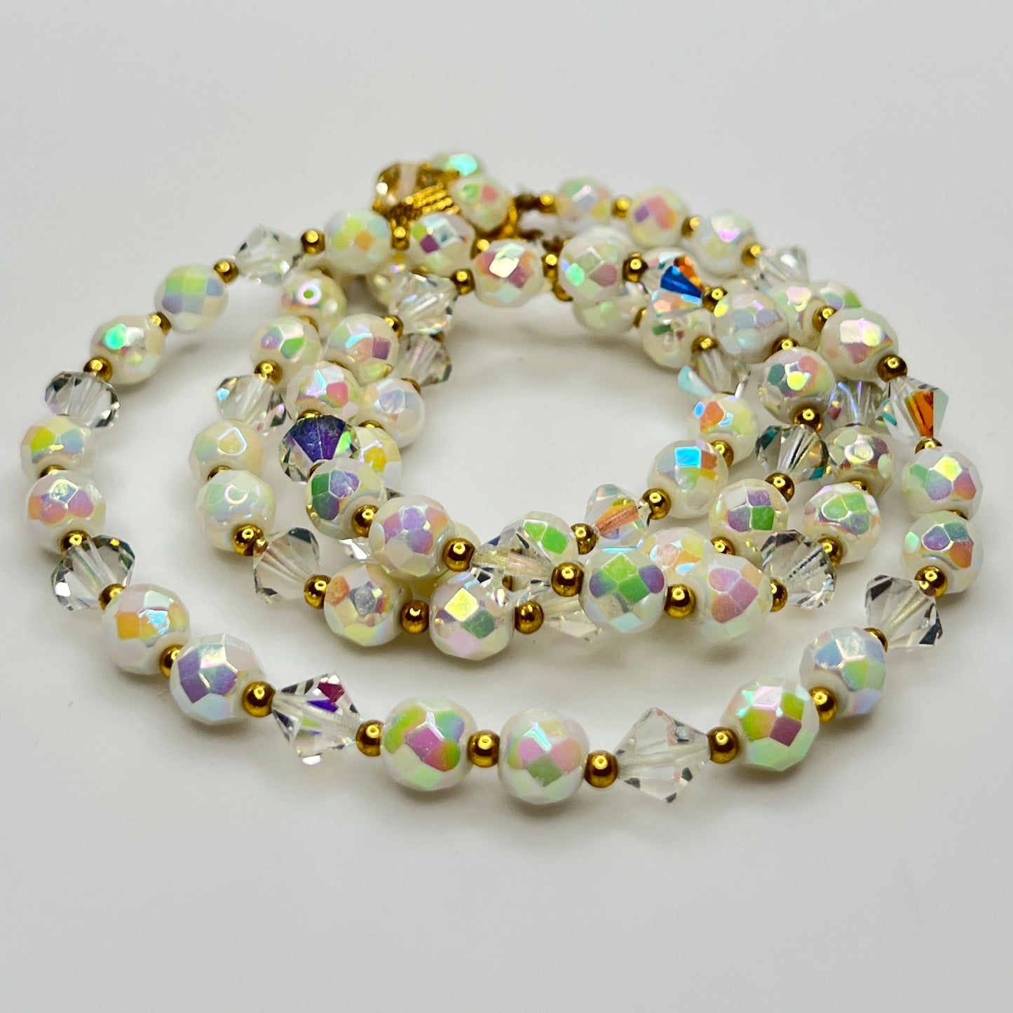 Detail of faceted AB beads and bicone crystals with gold spacers