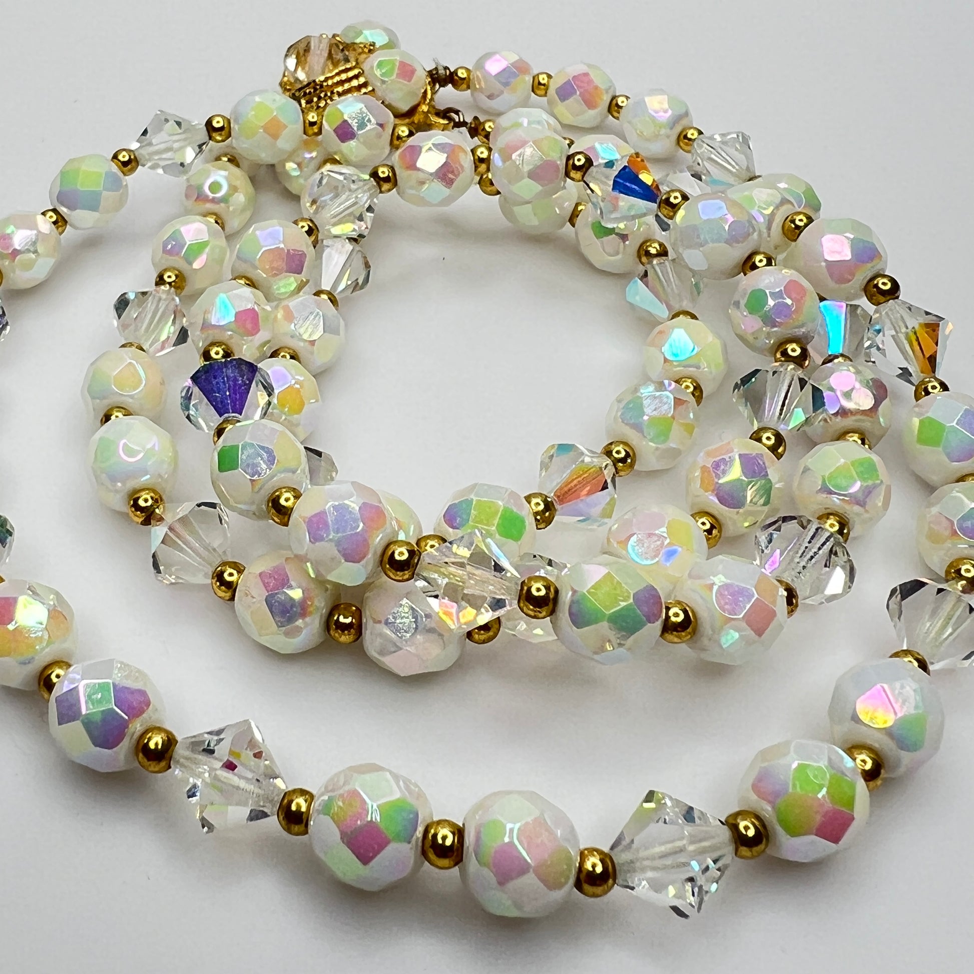 Detail of faceted AB beads and bicone crystals with gold spacers