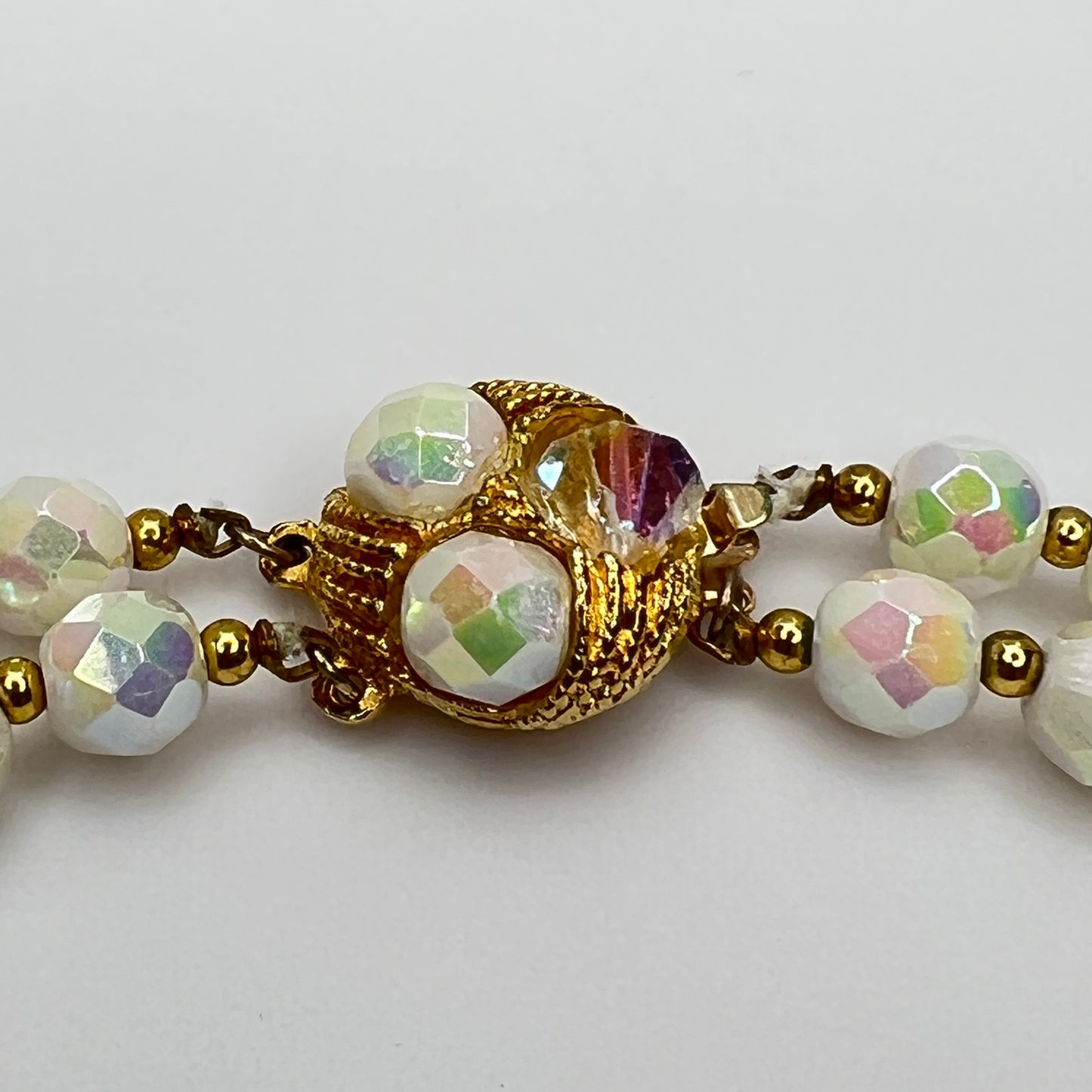 Close-up of ornate goldtone box clasp with coordinating bead accents