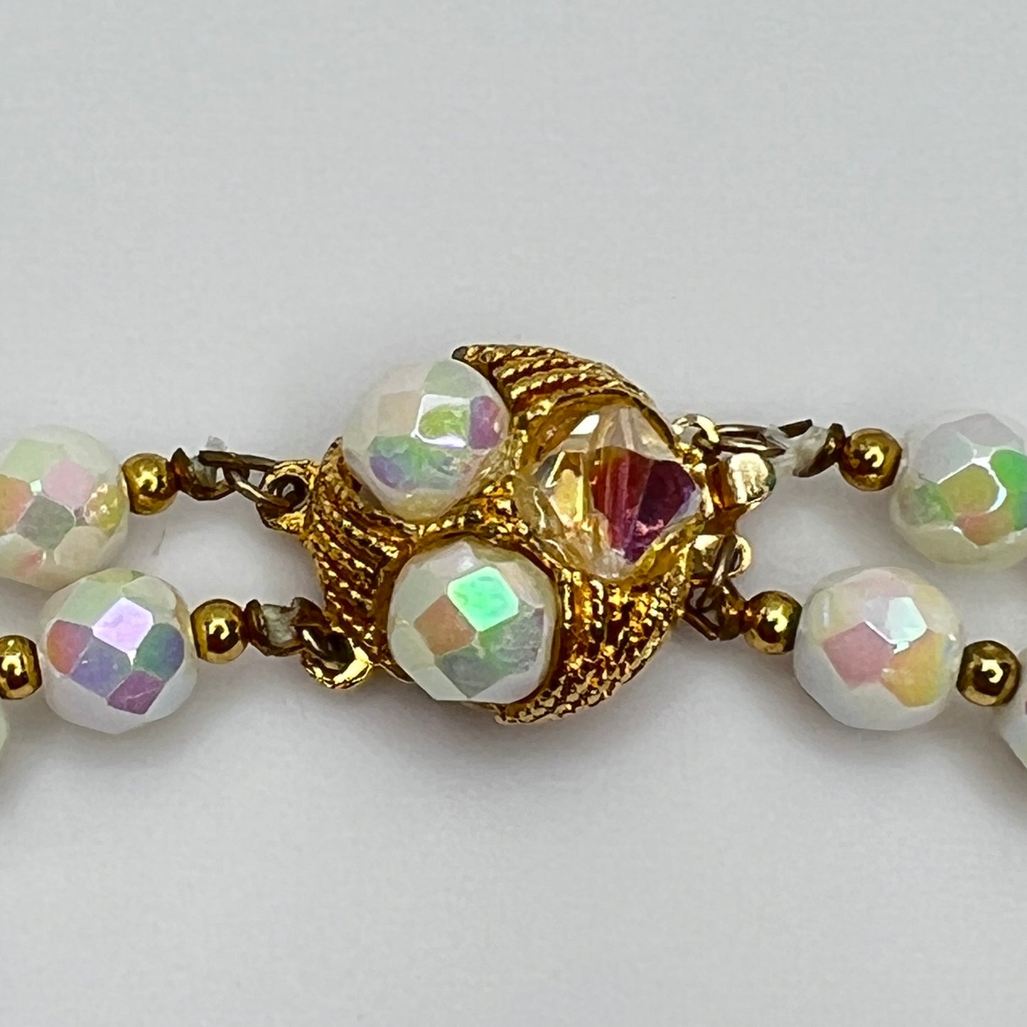 Close-up of ornate goldtone box clasp with coordinating bead accents