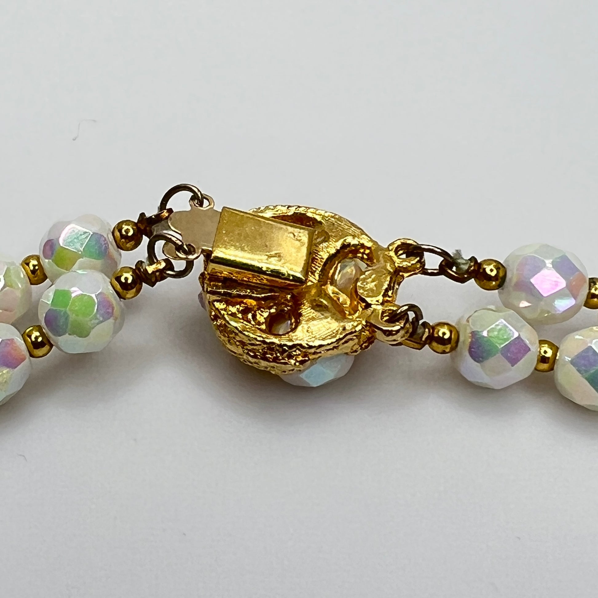 Close-up of ornate goldtone box clasp with coordinating bead accents